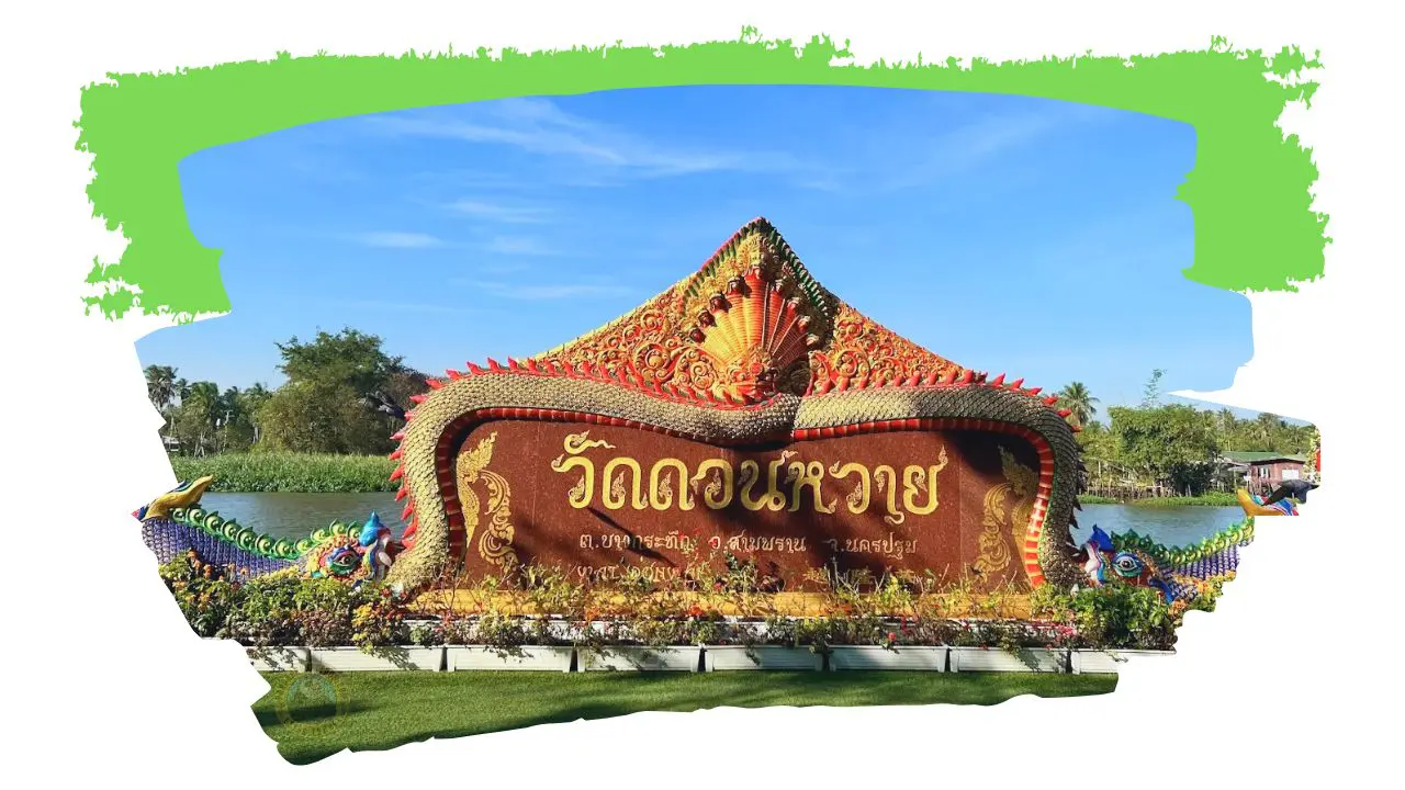 Insegna d'ingresso del tempio Wat Don Wai, con lettere thailandesi dorate e naga colorati, accanto al fiume